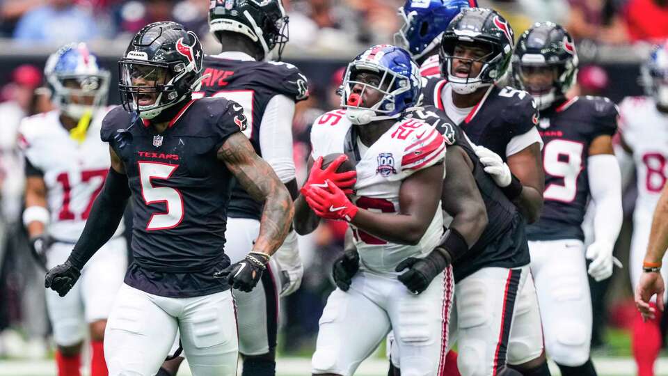 Houston Texans safety Jalen Pitre (5) celebrates after stopping New York Giants running back Devin Singletary (26) for no gain during the first half of an NFL preseason football game Saturday, Aug. 17, 2024, in Houston.