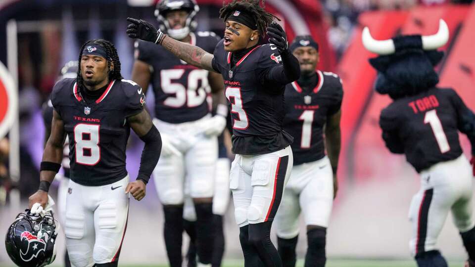 Houston Texans wide receivers John Metchie III (8) and Tank Dell (3) run onto the field as the team is introduced before an NFL preseason football game against the New York Giants Saturday, Aug. 17, 2024, in Houston.