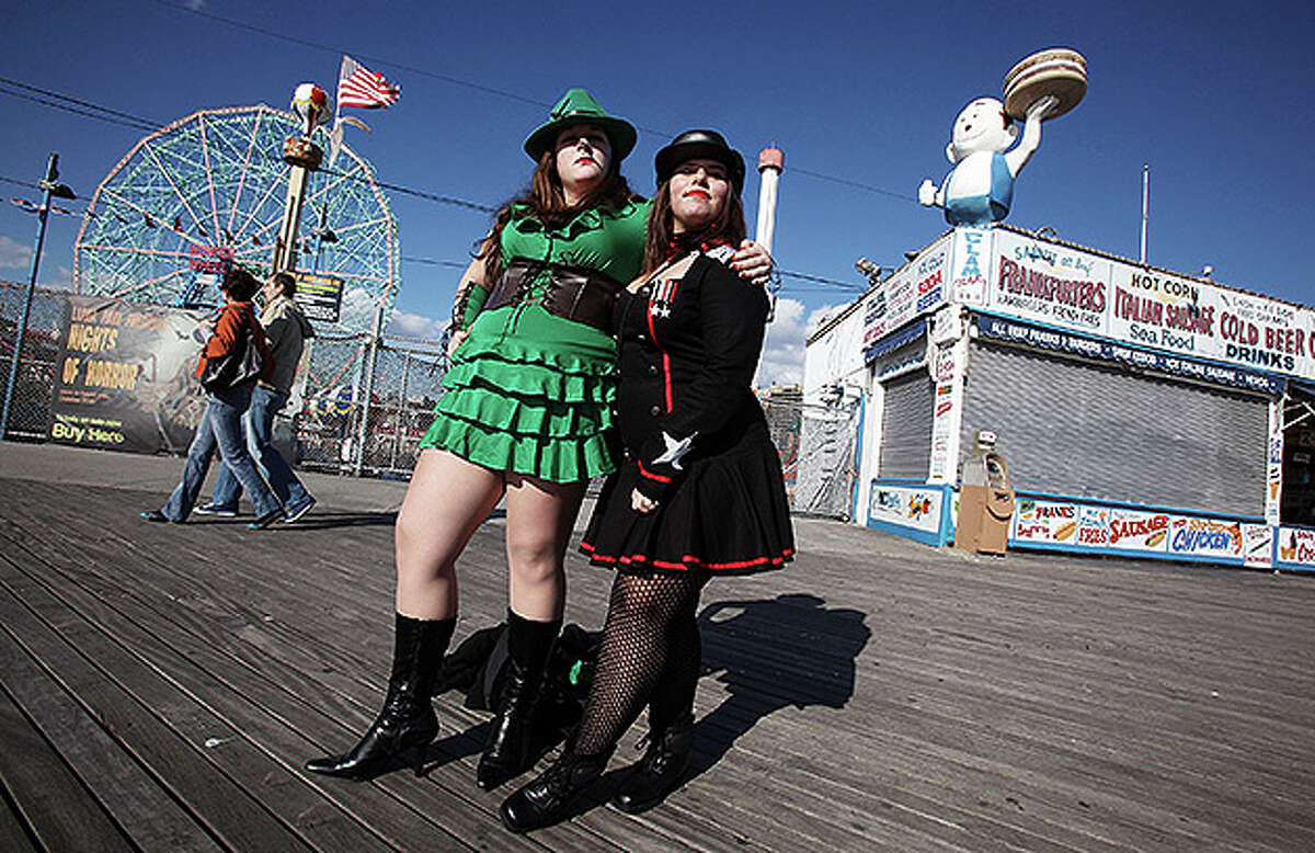 NEW YORK - OCTOBER 31: Costumed revelers Emily Morin (L) and Tara Eres pose on the boardwalk at historic Coney Island on Halloween October 31, 2010 in the Brooklyn borough of New York City. Revelers across the country are celebrating Halloween the day before the Christian tradition of All Saints' Day which honors the dead. (Photo by Mario Tama/Getty Images)