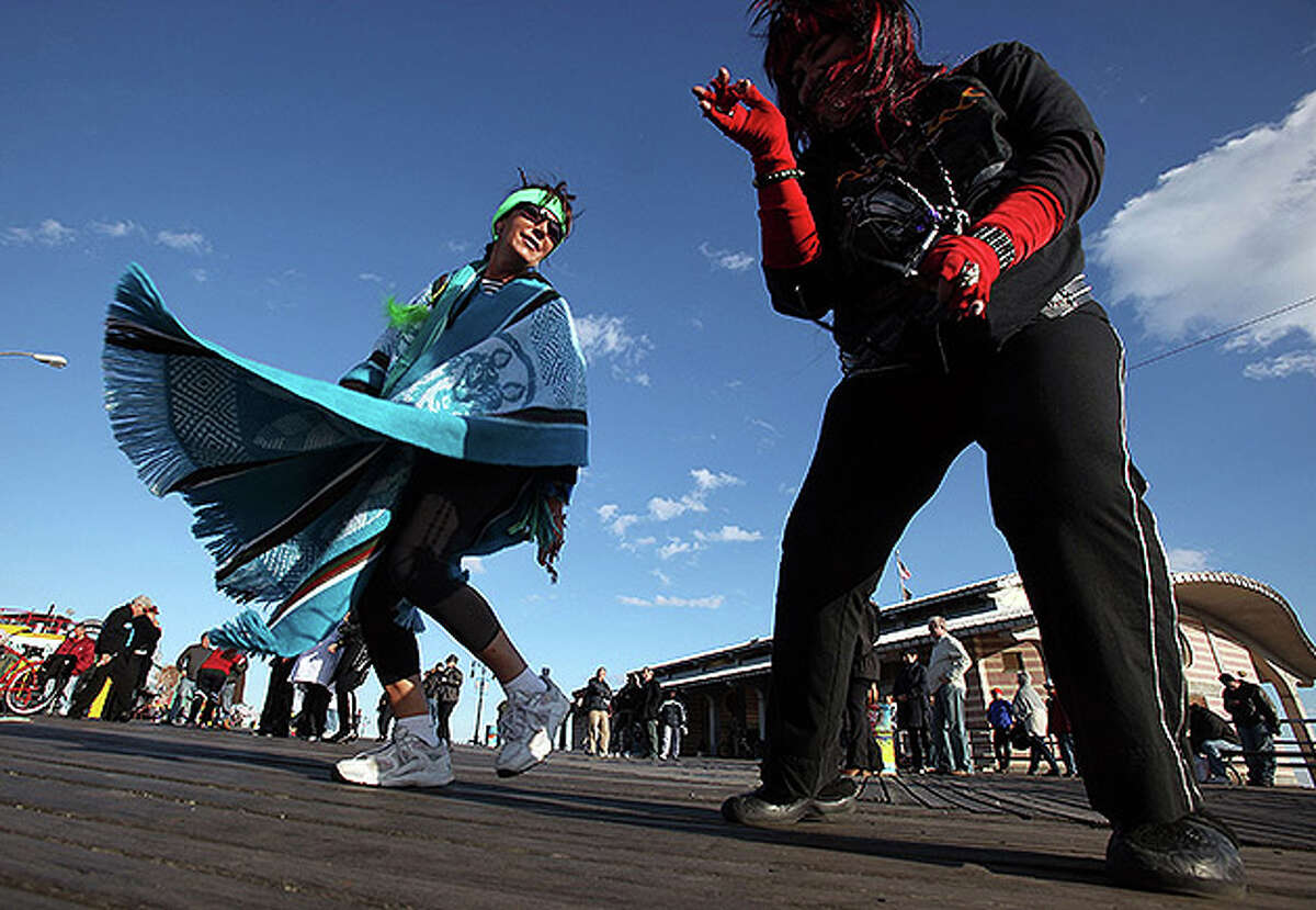 NEW YORK - OCTOBER 31: Costumed revelers dance on the boardwalk at historic Coney Island on Halloween October 31, 2010 in the Brooklyn borough of New York City. Revelers across the country are celebrating Halloween the day before the Christian tradition of All Saints' Day which honors the dead. (Photo by Mario Tama/Getty Images)