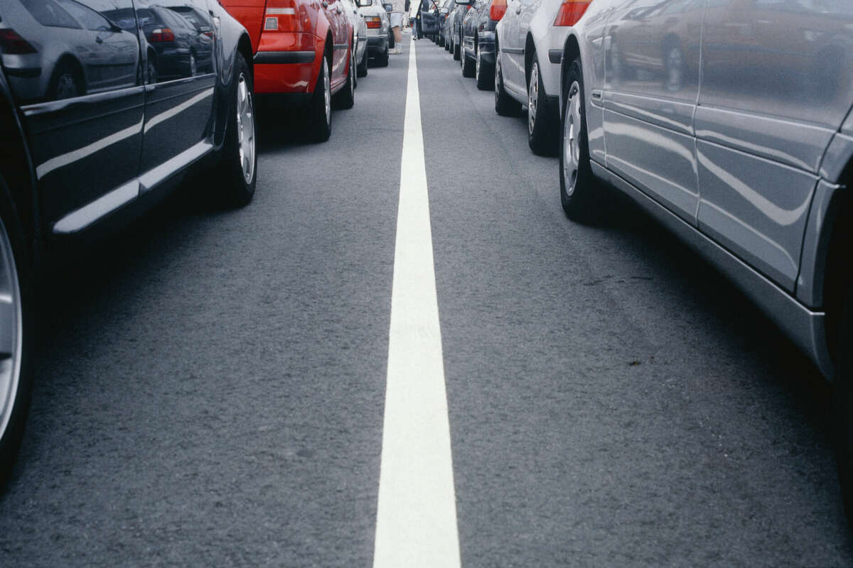 A line of cars along the road. 