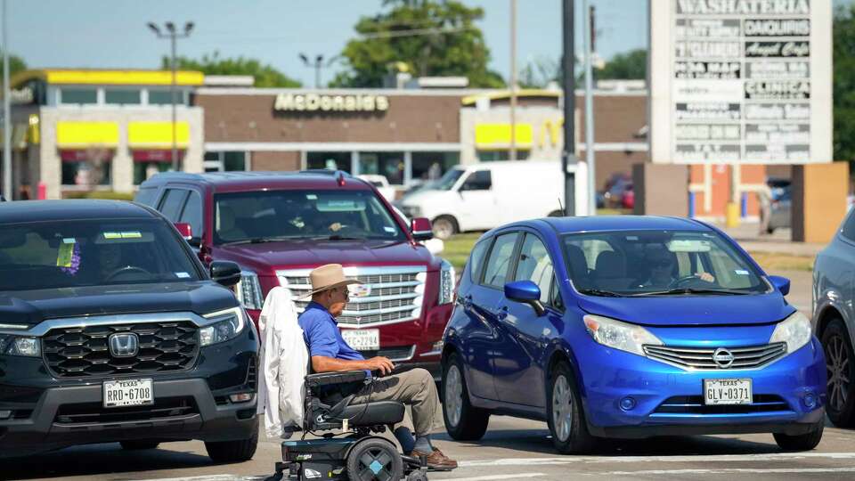 Pedestrians cross the street at the intersection of Beechnut and Wilcrest on Tuesday, Aug. 20, 2024 in Houston. The intersection is one that is among the hot spots for crashes related to children, including two fatalities.