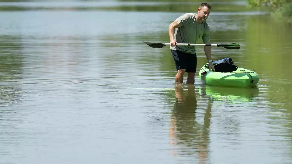 Blue Heron Bay resident Steve Smithers stands in the now shallow water that was once an access point to Lake Conroe for boats on Tuesday, Aug. 20, 2024 in Montgomery.