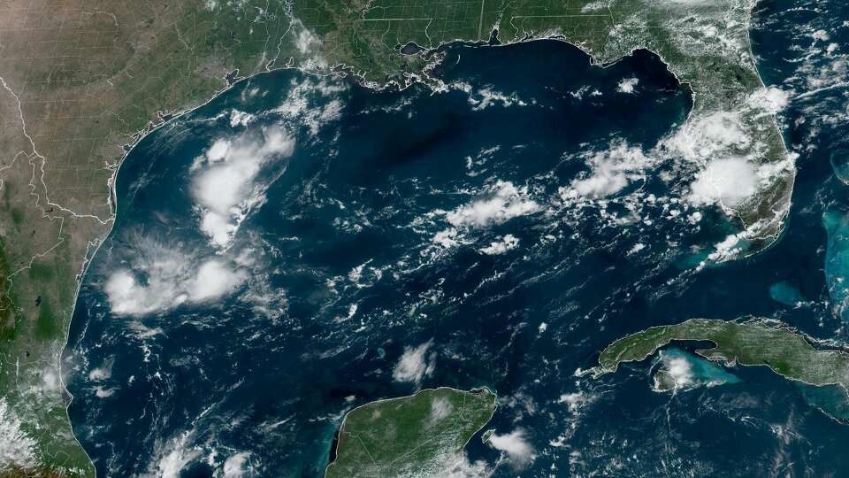 Shown is visible satellite imagery captured Wednesday, Aug. 21, above the Gulf of Mexico. Aside from a few pockets of thunderstorm activity, the Gulf remains quiet.