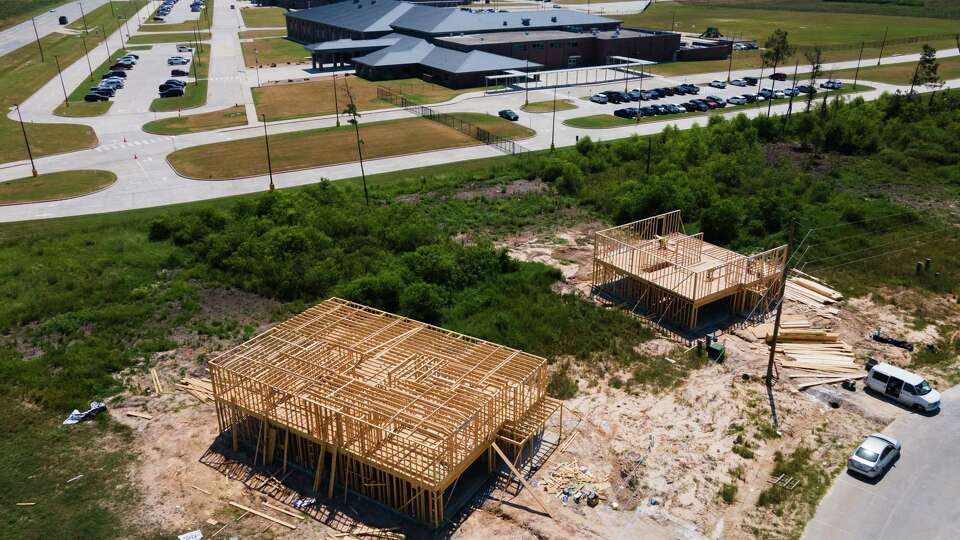 Workers continue progress on framing homes which boarder Cleveland ISD’s Santa Fe Elementary School in the Colony Ridge subdivision about 45 minutes northeast of Houston, Tuesday, Aug. 20, 2024, in Cleveland.