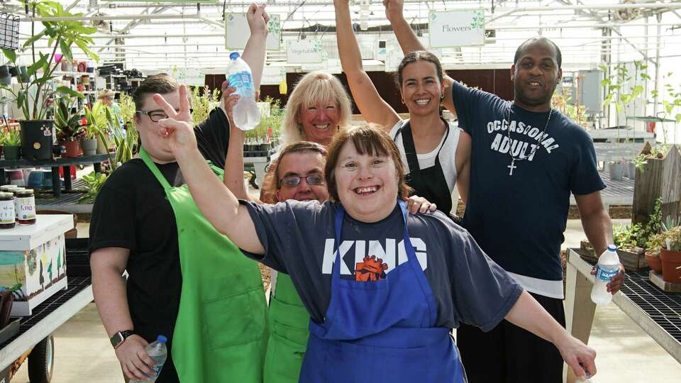 Program members and staff pose for a photo Wednesday, Aug. 21, 2024, at Reach Unlimited in Cypress.