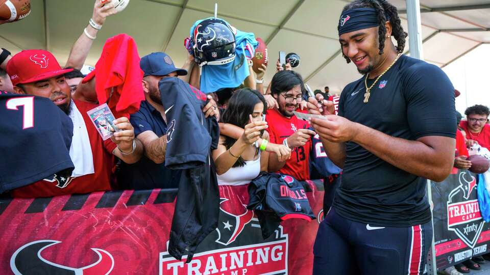 Houston Texans quarterback C.J. Stroud signs autographs during an NFL training camp Thursday, Aug. 22, 2024, in Houston.