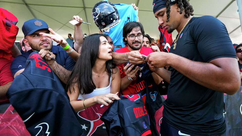 Houston Texans quarterback C.J. Stroud signs autographs during an NFL training camp Thursday, Aug. 22, 2024, in Houston.