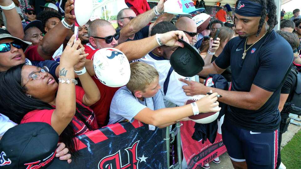 Houston Texans quarterback C.J. Stroud signs autographs during an NFL training camp Thursday, Aug. 22, 2024, in Houston.