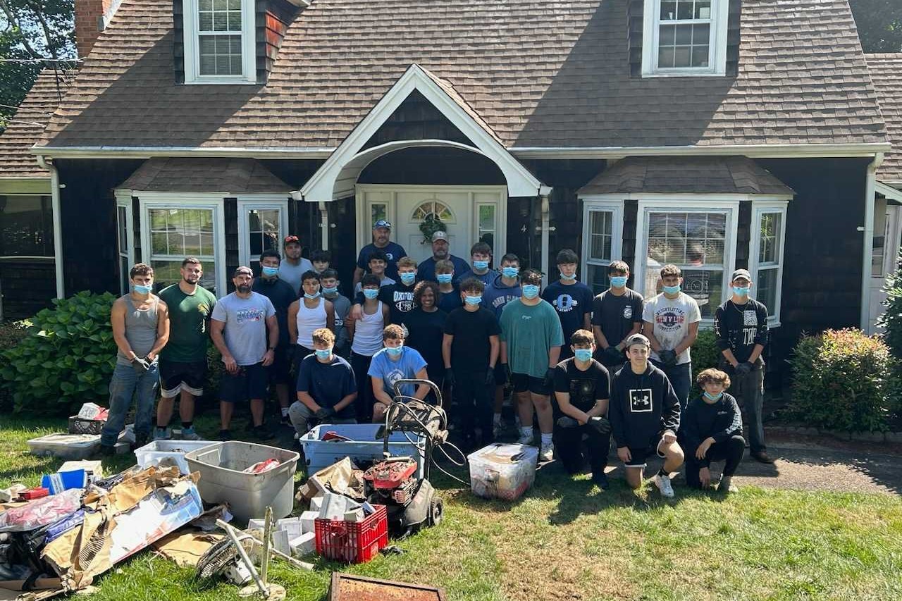 CT football team volunteers time, helps resident clean up house damage