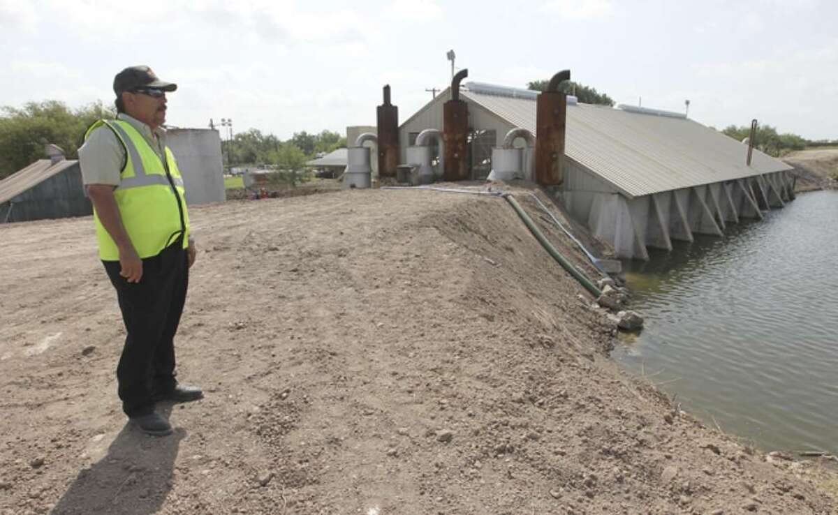 Richard Garza, superintendent of Edinburg Pump Station in Penitas, overlooks a newly reinforced levee as concerns of rising flood waters from the Rio Grande continue to be an issue along Texas border towns.