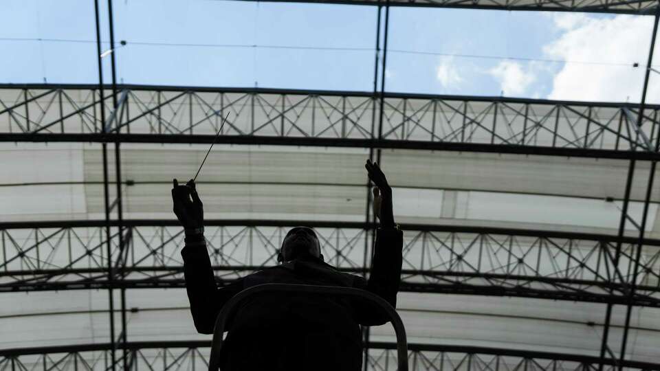 Bethune-Cookman University assistant band director Bree’shawn Watson conducts under a damaged roof as the marching band sits in the stands before the 2024 Pepsi National Battle of the Bands at NRG Stadium on Sunday, Aug. 25, 2024 in Houston.