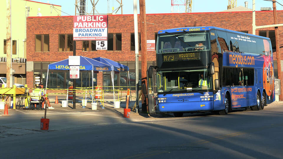 A Megabus transport bound for Houston sits parked by the pick up spot at a parking lot near the corner of Broadway and Fourth Street on Thursday, Oct. 18, 2012.