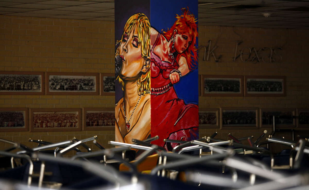 A mural by Vincent Valdez hangs in Burbank High's cafeteria. A soccer-themed mural he created on the side of Burbank's gym in 1994 was mistakenly painted over in June.