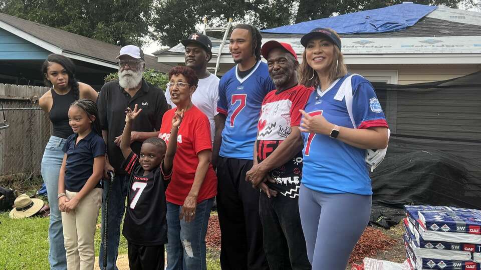 Nova Smith, in red T-Shirt, and her family were grateful for the assistance Texans quarterback C.J. Stroud, third from right, provided in getting their home repaired after it was damaged by Hurricane Beryl.