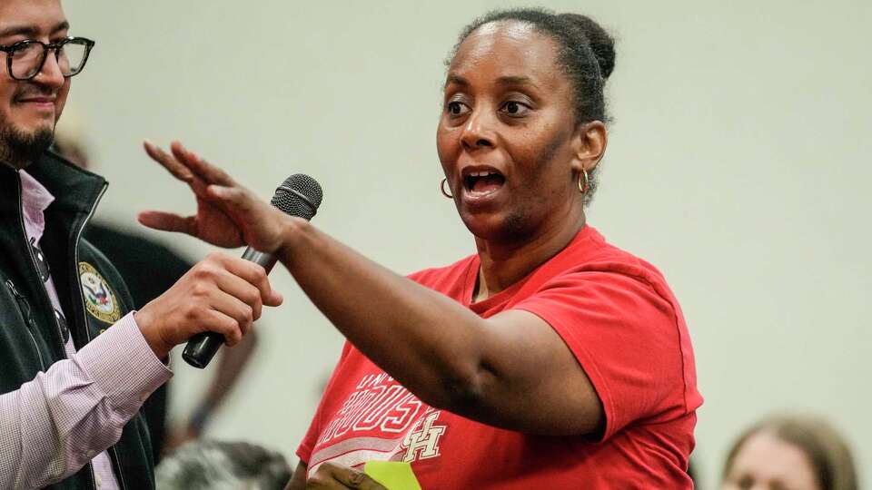 Michelle Williams asks a question to Congresswoman Sylvia Garcia and other panelists as they held a town hall, where they took questions about the Houston ISD Board of Managers' decision to approve an election on the $4.4 billion bond at Harris County Education Department on Tuesday, Aug. 27, 2024, in Houston.