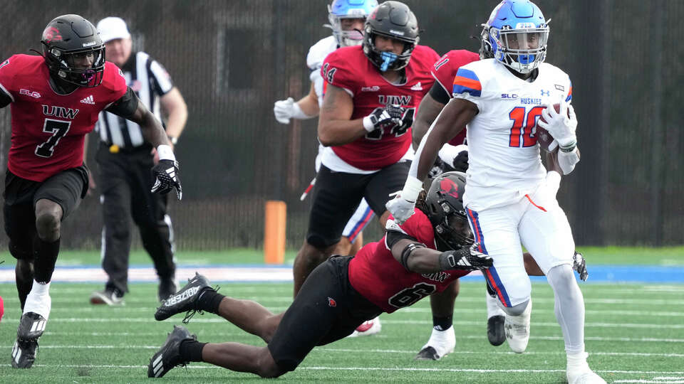 Houston Christian Huskies running back Darryle Evans (10) gains yardage against Incarnate Word Cardinals defensive back Ronald Wilson (6) during the first half of a college football game at Husky Stadium on Saturday, Nov. 18, 2023, in Houston.