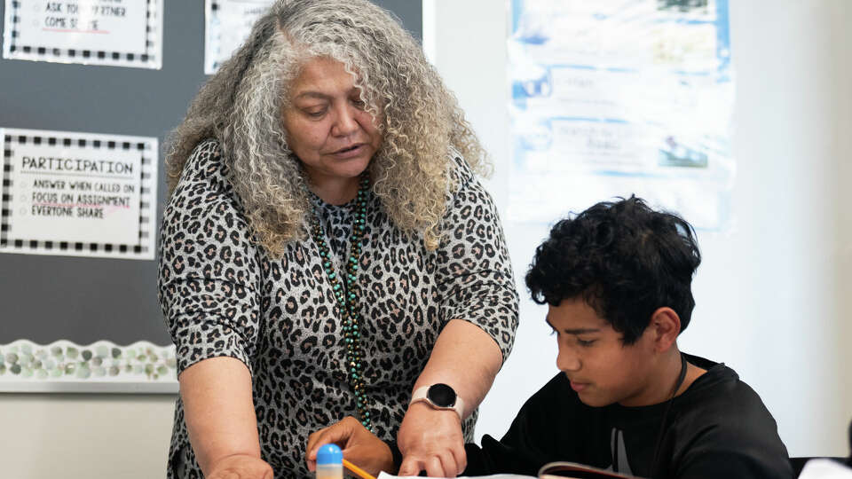 Teacher Anne Garcia with with Wilson Rivera Ortiz on his translations during his English as a Second Language class at Santa Fe Middle School, Tuesday, Aug. 20, 2024, in Cleveland.