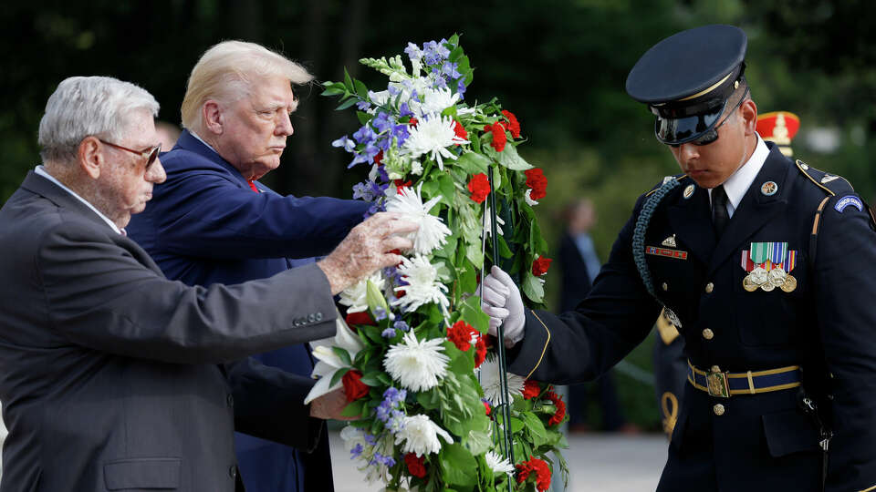 Republican presidential nominee, former U.S. President Donald Trump stands alongside Bill Barnett (L), who's grandson Staff Sgt Darin Taylor Hoover died in Abbey Gate Bombing, during a wreath laying ceremony at the Tomb of the Unknown Soldier at Arlington National Cemetery on August 26, 2024 in Arlington, Virginia. 