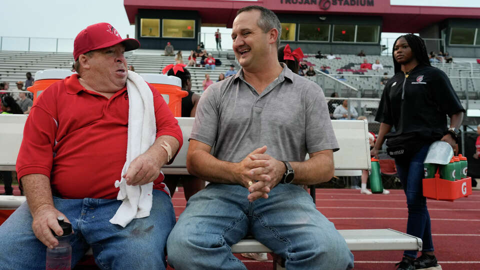 Texas State Rep. Ernest Bailes IV, right, sits down to talk and joke alongside Coldspring High School football team manager Robby Roseman before Coldspring High School’s rivalry football game against Shepherd, Friday, Oct. 27, 2023, in Coldspring.