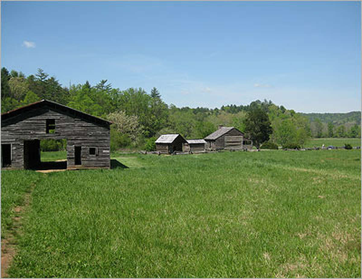 The Dan Lawson Place is Site No. 15 on the Cades Cove loop. The hours was built in 1856. The small building closest to the house is a granary, and the other is a smokehouse.