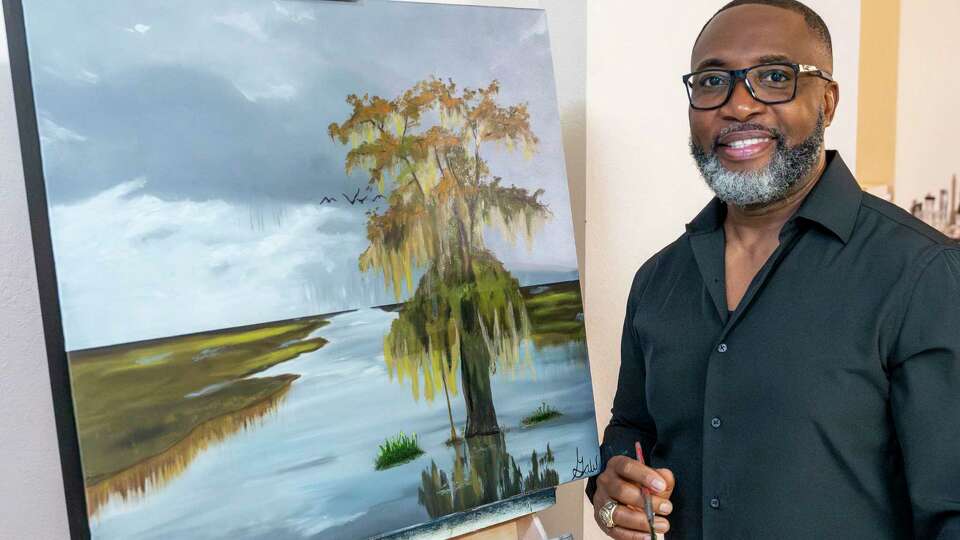 Artist and U.S. Marine Corps veteran Gaw Jones Jr. poses with his latest work Friday, Aug. 30, 2024 in Friendswood.