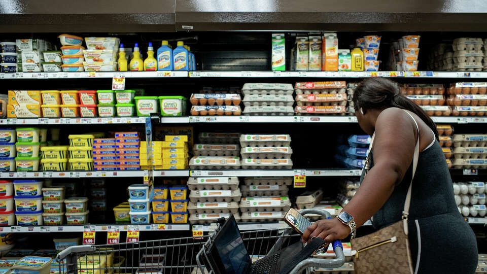 A customer shops for eggs in a Kroger grocery store on Aug. 15, 2022, in Houston, Texas. Even as inflation cools, prices are still higher than many are accustomed to. Grocery prices are up 25% since 2020; it had taken 16 years for the previous 25% rise in prices. (Brandon Bell/Getty Images/TNS)