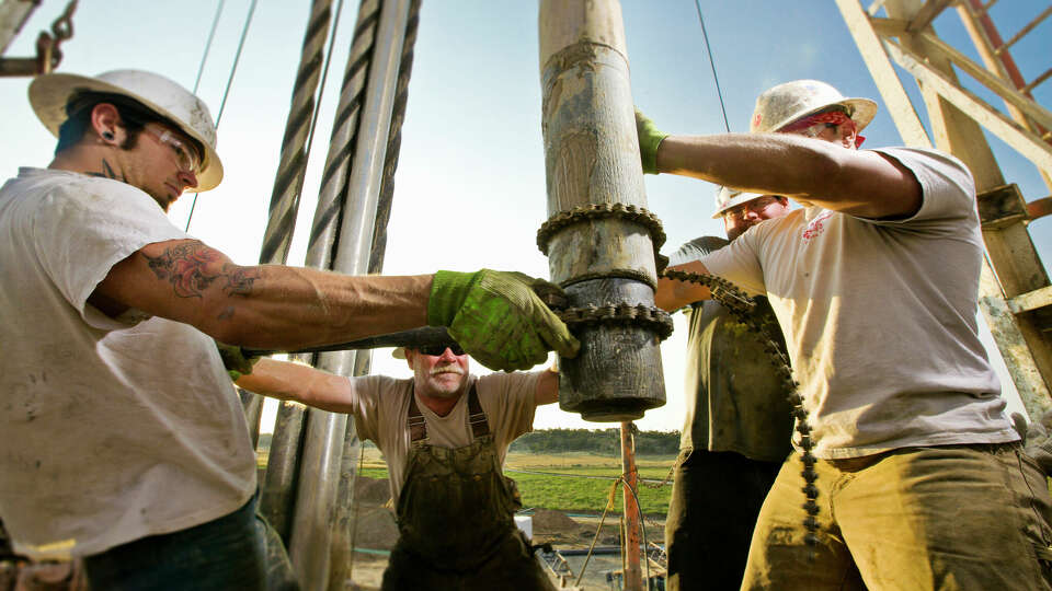 Roughnecks work on an oil rig. 