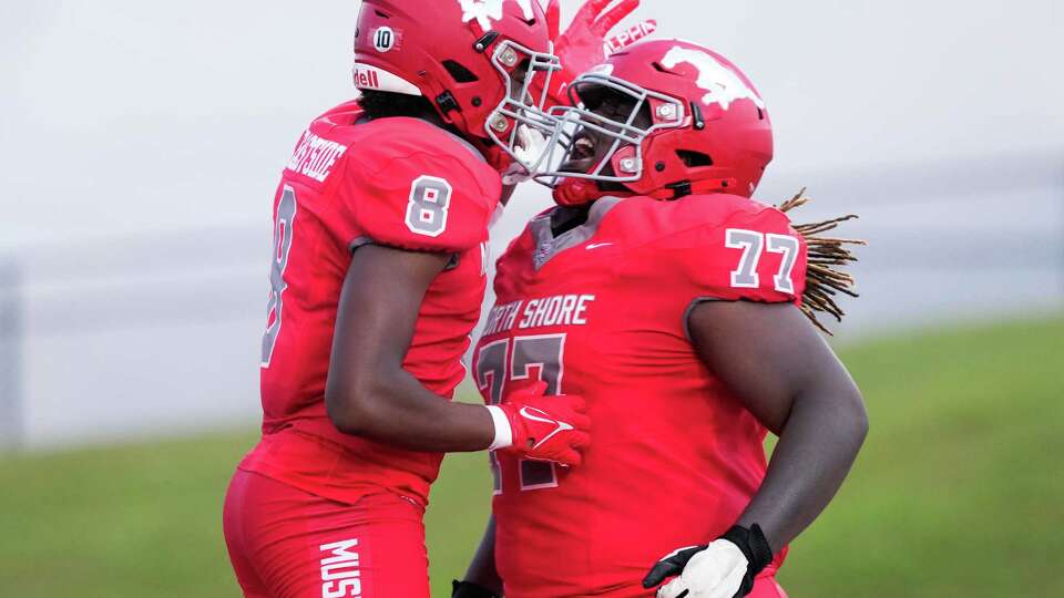 North Shore wide receiver Cameron Smith (8) celebrates with offensive lineman Jakoby Isom (77) after scoring a 43-yard touchdown during the second quarter of a non-district high school football game at Galena Park ISD Stadium, Friday, Aug. 30, 2024, in Houston.