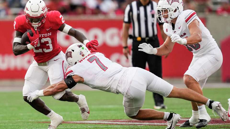 Houston running back Parker Jenkins (23) runs the ball around the end against UNLV linebacker Jackson Woodard (7) during the first half of an NCAA college football game Saturday, Aug. 31, 2024, in Houston.