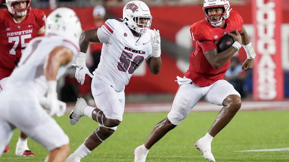 Houston quarterback Donovan Smith (1) is chased out of the pocket by UNLV defensive lineman Jalen Dixon (50) during the second half of an NCAA college football game Saturday, Aug. 31, 2024, in Houston.