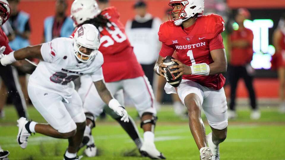 Houston quarterback Donovan Smith (1) scrambles in the pockets against UNLV during the second half of an NCAA college football game Saturday, Aug. 31, 2024, in Houston.