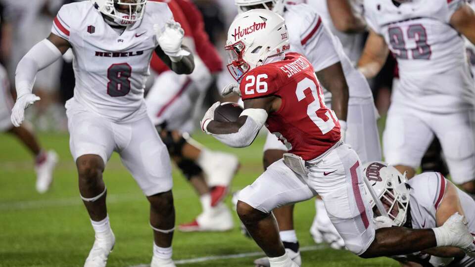 Houston running back Re'Shaun Sanford II (26) is stopped at the line of scrimmage by the UNLV defense during the second half of an NCAA college football game Saturday, Aug. 31, 2024, in Houston.