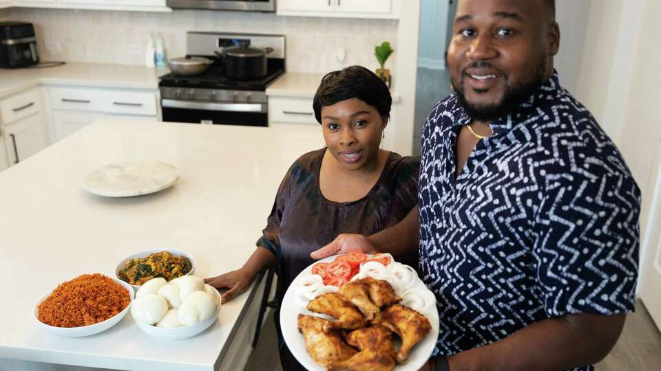 Chef Opeyemi ‘Ope’ Amosu and cook Elizabeth Jagun are seen alongside various West African dishes, Sunday, Sept. 1, 2024, in Richmond. Amosu is working on opening up a brick and mortar location of ChopnBlok.