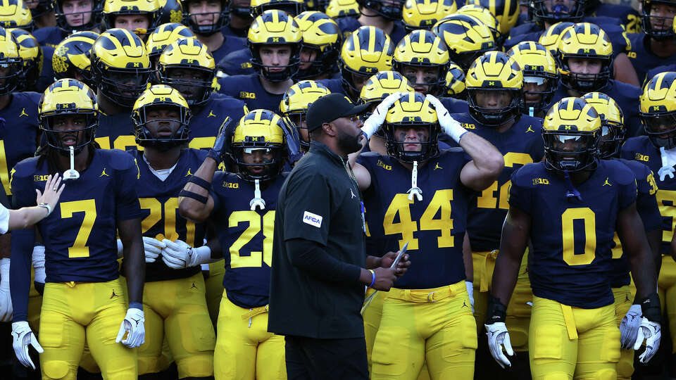 Michigan has a new head coach in Sherrone Moore, shown leading team on to the field for opener against Fresno State. Texas is at Michigan on Saturday.