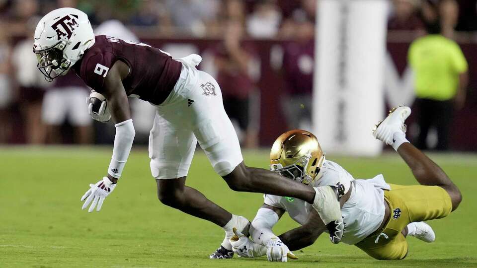 Texas A&M wide receiver Jahdae Walker (9) steps out of a tackle attempt by Notre Dame linebacker Jaiden Ausberry (4) during the second half of an NCAA college football game Saturday, Aug. 31, 2024, in College Station, Texas. (AP Photo/Sam Craft)