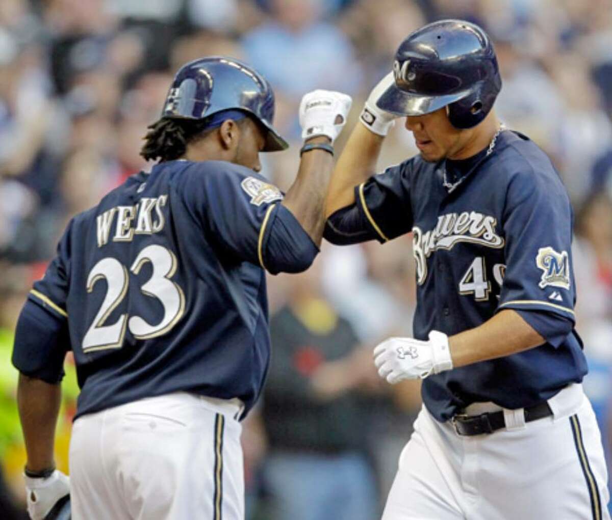 Brewers pitcher Yovani Gallardo (right) is congratulated by teammate Rickie Weeks after hitting a home run.