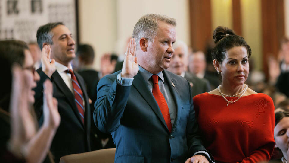 State Rep. David Cook, R-Mansfield, takes the oath of office with his hand on a Bible on the first day of the 88th Legislature on Jan 10, 2023.