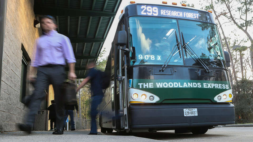 Bus riders depart The Woodlands Express at the park and ride location near Gosling Road, Tuesday, Jan. 17, 2022, in The Woodlands.