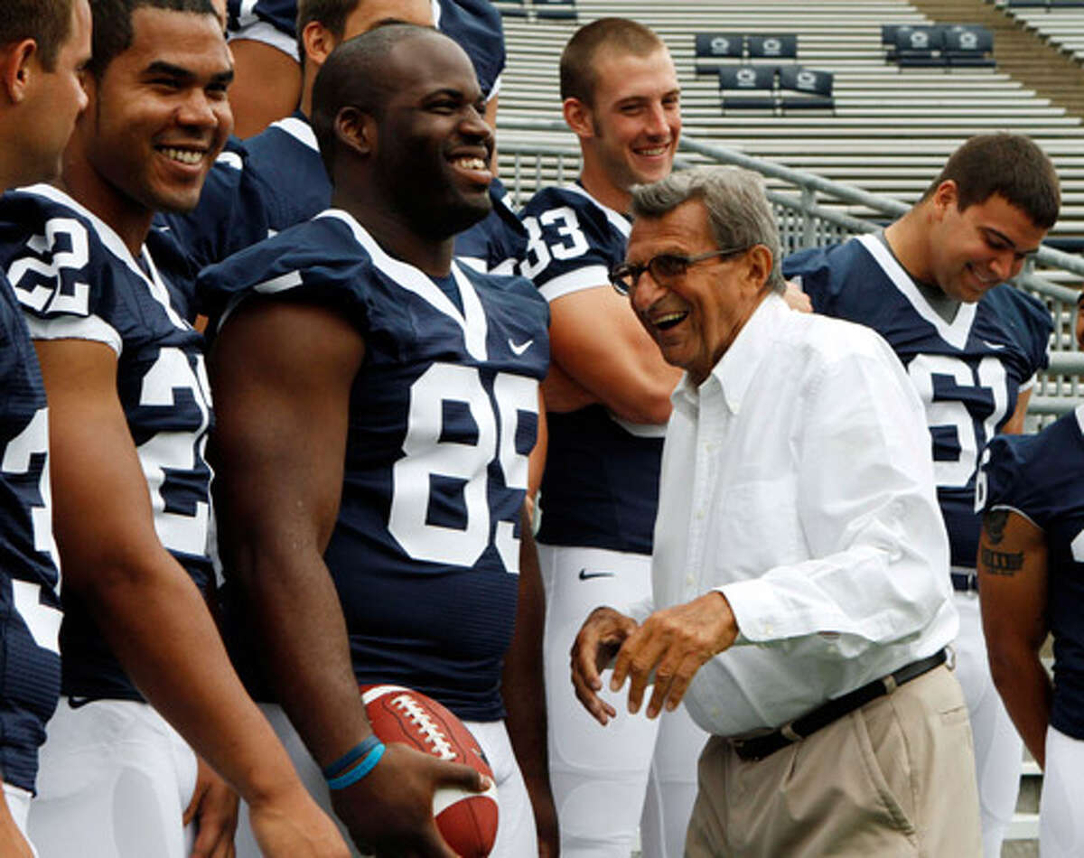 Penn State coach Joe Paterno laughs with some of his players, including (from left) Evan Royster, Ollie Ogbu, Brett Brackett and Stefen Wisniewski. Paterno has 394 wins entering the 2010 season.