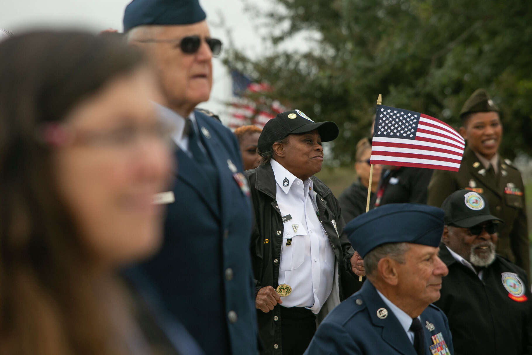 Debra Eaton, a Women’s Army Corp veteran, waves a flag during the Veterans Day Ceremony at Fort Sam Houston National Cemetery on Saturday, Nov. 11, 2023 in San Antonio.