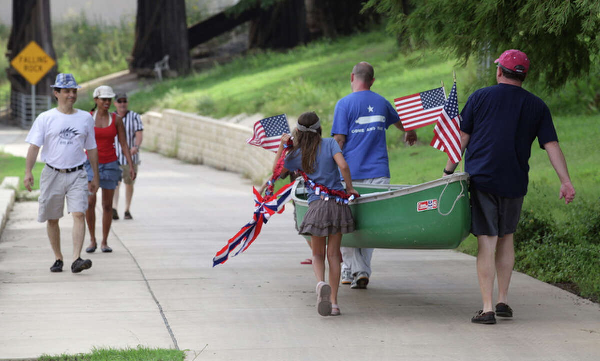 Boaters take their canoe down to the San Antonio River for the annual July 4th King William Yatch Club paddling of the Eagle Land section of the San Antonio River, July 4, 2010.