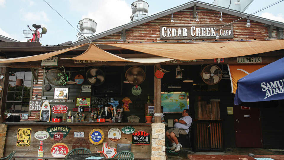 A customer relaxes at the outside bar at Cedar Creek Cafe, Sept. 14, 2013 in Houston. 