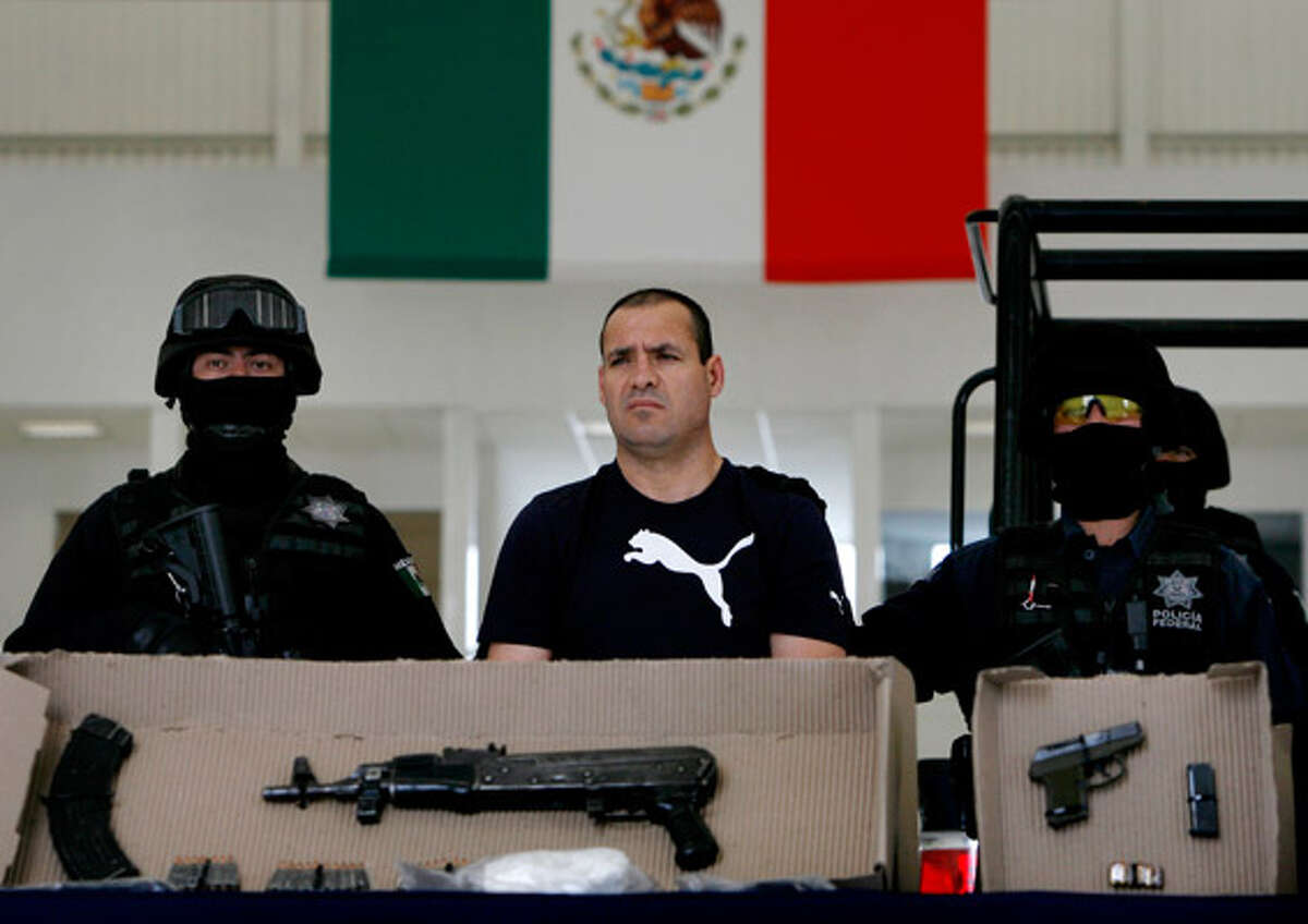 Police show Luis Vazquez Barragan and weapons they say they seized from him to the press in Mexico City after his arrest. They say he's a top member of La Linea gang, the enforcement arm of the Ju?rez cartel. La Linea is blamed in a recent car bombing that killed three people in Ju?rez this month.