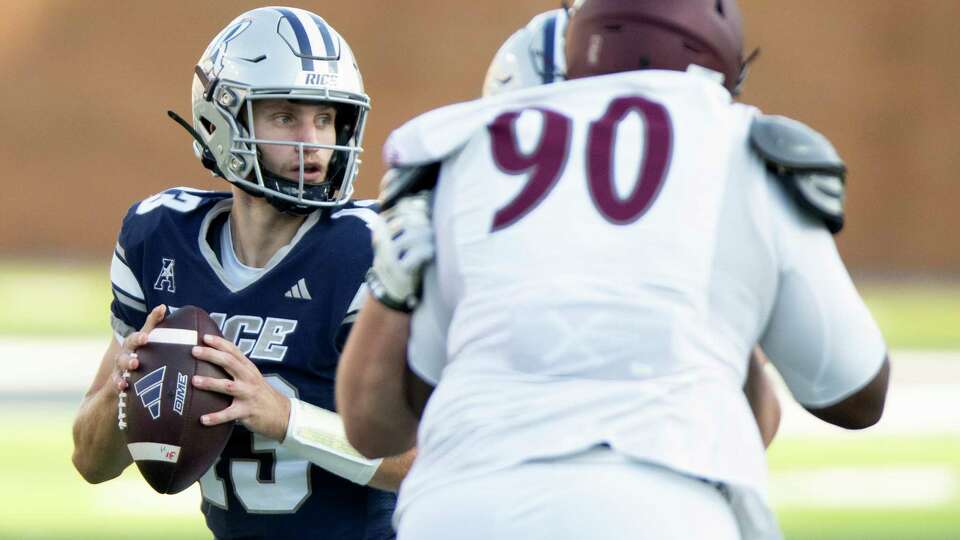 Rice quarterback E.J. Warner (13) looks to pass during the first half of a non-conference NCAA college football game at Rice Stadium, Saturday, Sept. 7, 2024, in Houston.