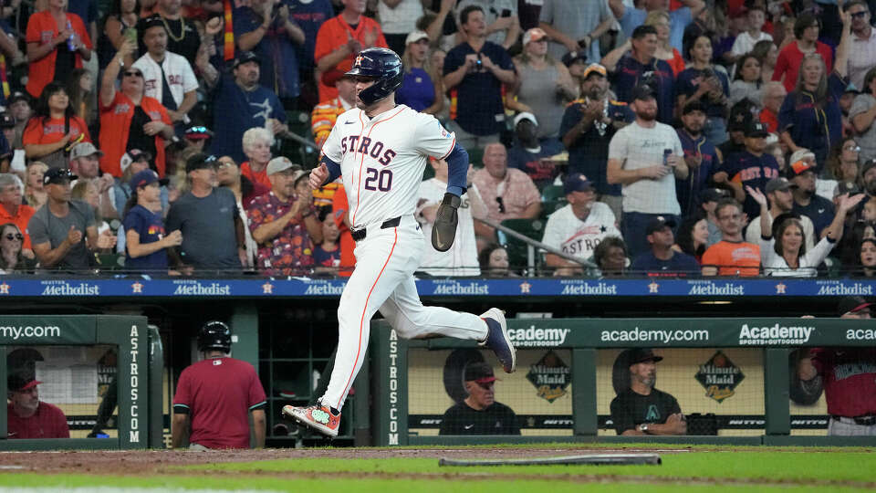 Houston Astros' Chas McCormick (20) scores a run on Houston Astros Yainer Diaz’s RBI single during the sixth inning of an MLB game at Minute Maid Park on Saturday, Sept. 7, 2024, in Houston.