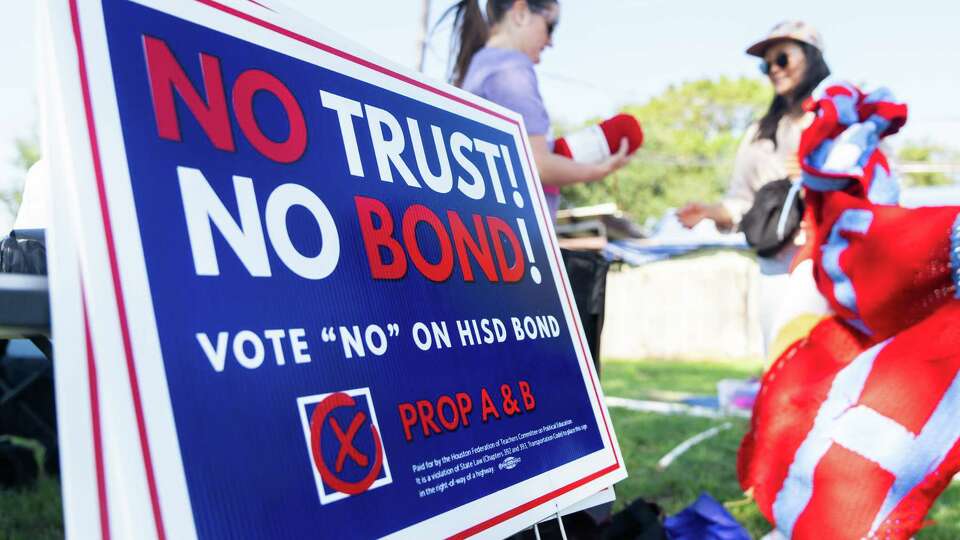 A sign that reads ‘No Trust! No Bond!’ is seen as members of the group Houston Stitching Together meet to work on protest signs against Houston ISD, Sept. 8, 2024, in Houston.