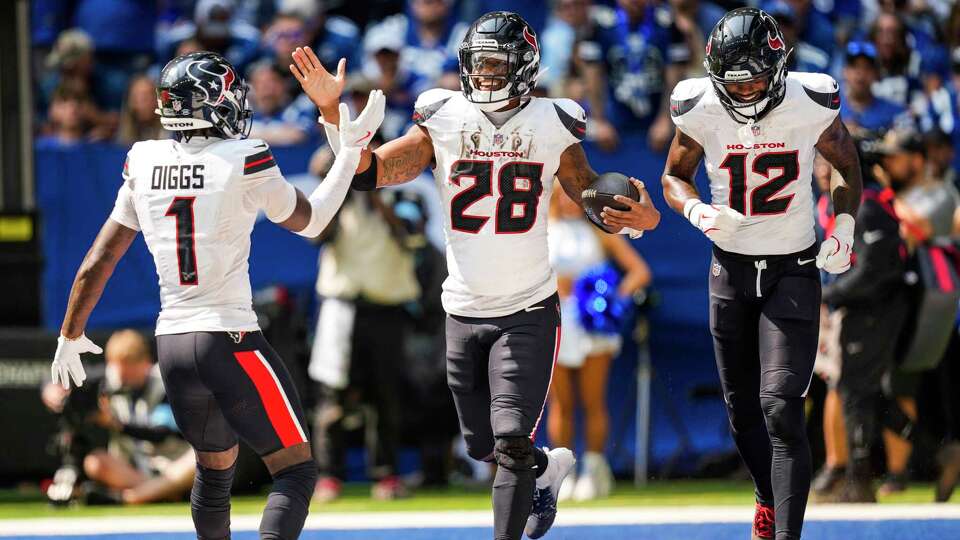 Houston Texans wide receiver Stefon Diggs (1), running back Joe Mixon (28) and Nico Collins celebrate Mixon’s 3-yard touchdown run against the Indianapolis Colts during the second half of an NFL football game Sunday, Sept. 8, 2024, in Indianapolis.