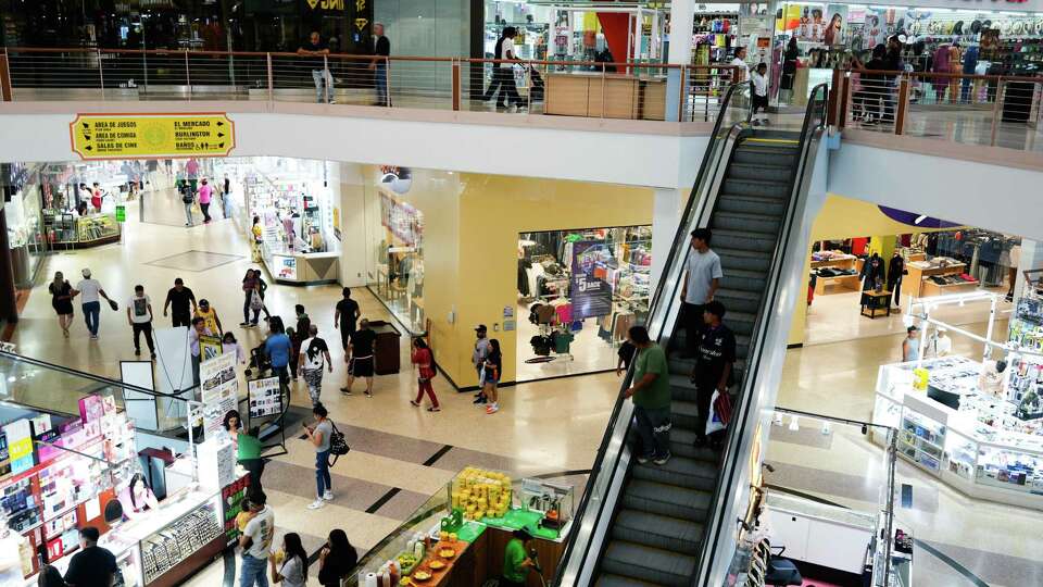 Shoppers walk through PlazAmericas, formerly Sharpstown Mall, Sept. 8, 2024, in Houston. The retail complex, originally named Sharpstown Center, was the first air-conditioned mall in the U.S., when it opened on Sept. 14, 1961.