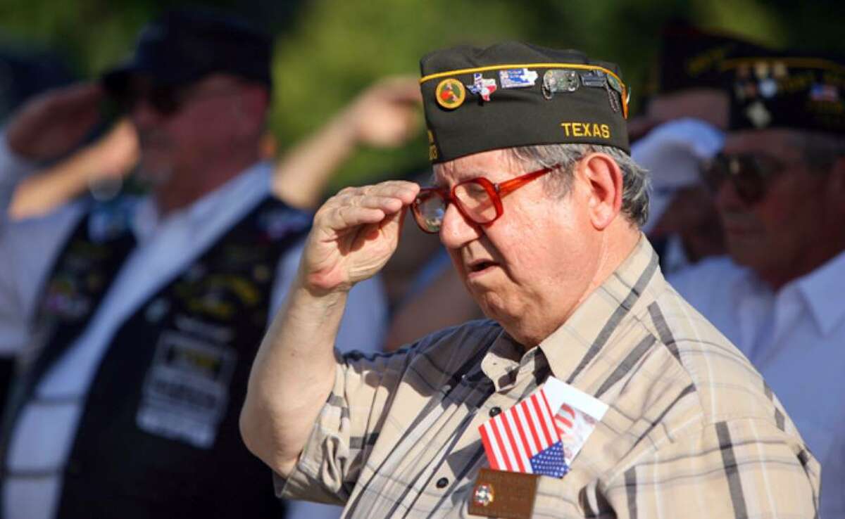 Leonard Childs, a member of VFW Post 9603, salutes as a flag is retired during the ceremony at VFW Post 837.